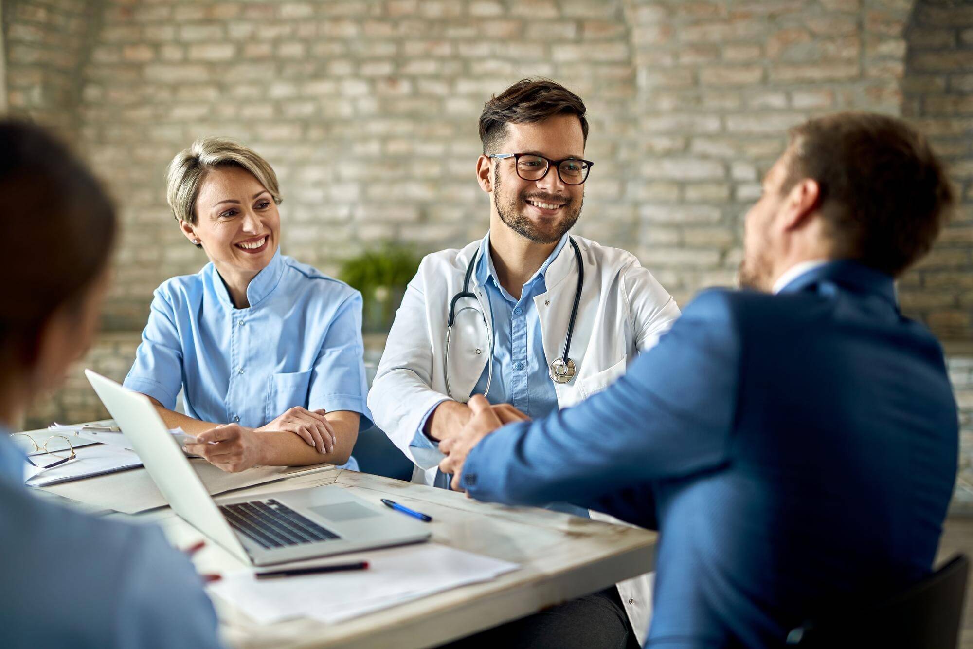 group healthcare workers greeting financial advisor meeting office focus is young doctor 637285 6709.jpg
